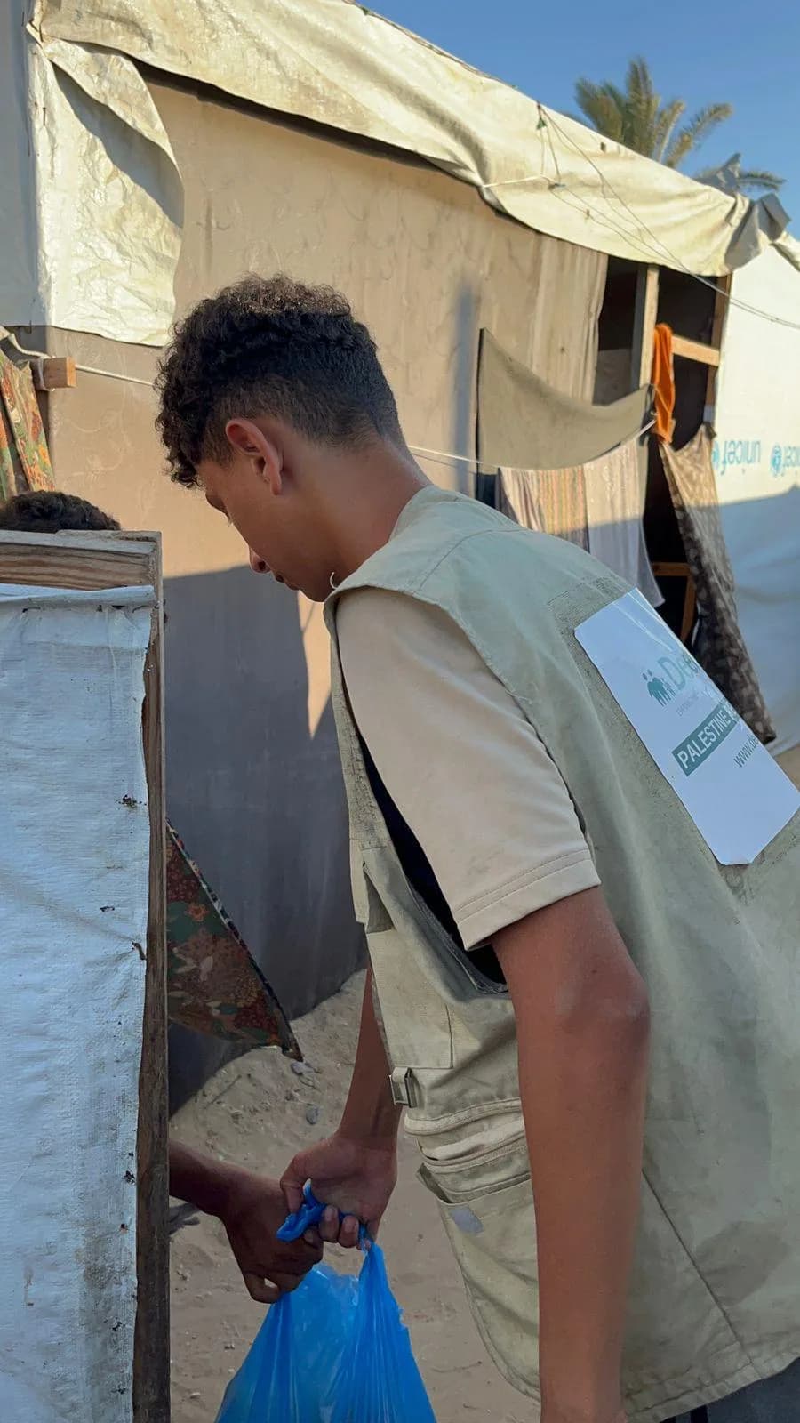 Deen Relief field worker delivering aid in a Gaza displacement camp