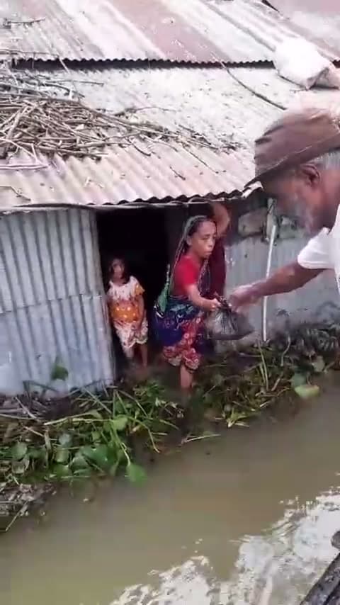 Deen Relief team distributing Qurbani 2024 meat parcels by boat to families in rural Bangladesh